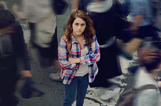 Someone surrounded by people, looking anxious